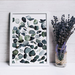 May include: A white framed print with a watercolor illustration of eucalyptus leaves in shades of green and blue on a white background.