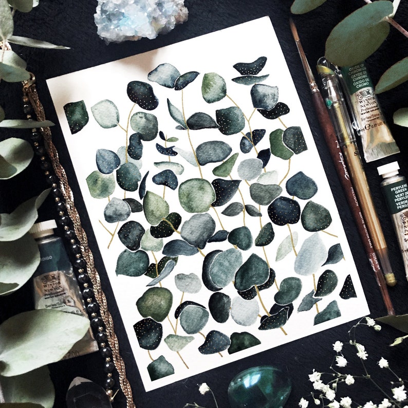 May include: Watercolor painting of eucalyptus leaves in shades of green and blue on a white background. The leaves are arranged in a random pattern and have a delicate, hand-painted look.