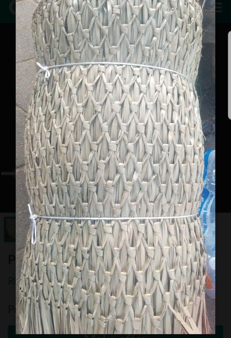 May include: A roll of natural woven material, possibly for crafting or gardening. The material is light brown and has a woven pattern. It is tied with white string.