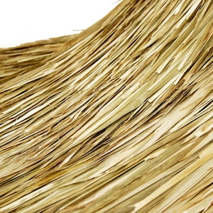 May include: Close-up of a woven texture made of thin, light brown strips of natural material. The strips are arranged in a diagonal pattern, creating a textured surface.