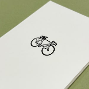 May include: A black and white illustration of a bicycle on a white background.