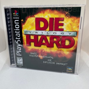 May include: A PlayStation game case for Die Hard Trilogy. The case is red and black with a picture of a fiery explosion. The text on the case reads "Die Hard Trilogy" and "three maximum adventures, one explosive package!"