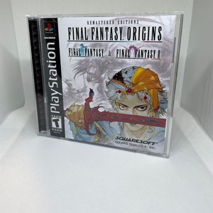 May include: A PlayStation game case with a blue and white illustration of a man holding a sword. The title of the game is "Final Fantasy Origins: Final Fantasy & Final Fantasy II" and the game is remastered. The game is rated T for Teen by the ESRB.