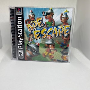 May include: A PlayStation game case with a blue background and the title "Ape Escape" in yellow and red letters. The cover art features five cartoon monkeys wearing hats and sunglasses. The game is rated "E" for Everyone by the ESRB.