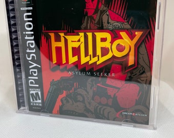 May include: A PlayStation game case for Hellboy: Asylum Seeker. The cover art features a red-skinned character with horns and a gun. The game is rated M for Mature by the ESRB. The game is published by Dreamcatcher.