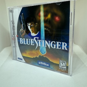 Könnte beinhalten: Ein Sega Dreamcast-Spielcase für Blue Stinger. Das Case ist aus durchsichtigem Plastik und zeigt die Covergrafik des Spiels. Die Covergrafik zeigt einen Mann mit einer Waffe, ein blaues Licht und ein Monster mit roten Augen. Das Spiel ist von der ESRB mit M für Mature bewertet.