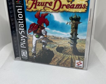 May include: A PlayStation game case for Azure Dreams, a role-playing game for the PlayStation console. The case features a blue sky background with a red-haired character standing on a rock, a tower in the distance, and the game title in a stylized font.