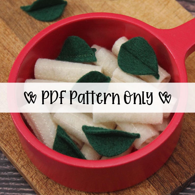 K&ouml;nnte beinhalten: Eine rote Filzpfanne gef&uuml;llt mit Filz-Pasta und gr&uuml;nen Filzbl&auml;ttern. Der Text "PDF Pattern Only" wird auf dem Bild angezeigt. Die Pasta ist wei&szlig; und die Bl&auml;tter sind dunkelgr&uuml;n.