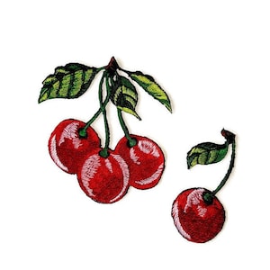 May include: Three red cherries with green stems and leaves, and one single red cherry with a green stem and leaf. The cherries are embroidered on a white background.