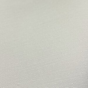 May include: A close-up of a white fabric with a textured surface.