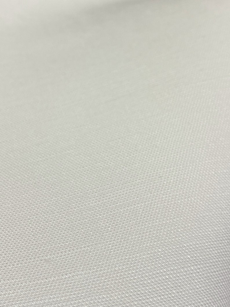 May include: A close-up of a white fabric with a textured surface.