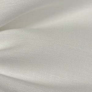 May include: White tulle fabric with a fine, even weave. The fabric is soft and delicate, with a slightly sheer appearance.