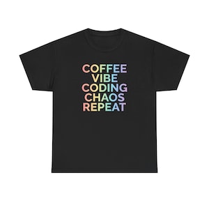 May include: Black t-shirt featuring the text "COFFEE VIBE CODING CHAOS REPEAT" in a rainbow gradient. The words are stacked vertically. The shirt has a round neck and short sleeves.