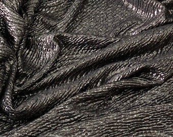 May include: Black fabric with a metallic sheen and a textured, wavy pattern.