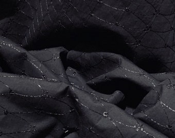 May include: Black fabric with a subtle, repeating pattern of silver thread embroidery. The fabric is wrinkled and folded.