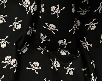 May include: Black fabric with a repeating pattern of white skull and crossbones.