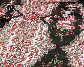 May include: Black sheer fabric with a floral and paisley pattern in shades of red, pink, and cream.