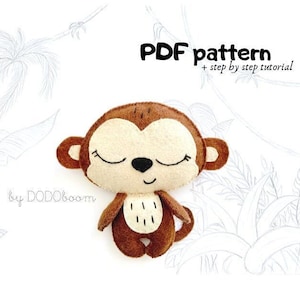 May include: A PDF pattern for sewing a brown felt monkey with closed eyes. The pattern includes a step-by-step tutorial.  The monkey is sitting with its legs crossed and has a small black nose.