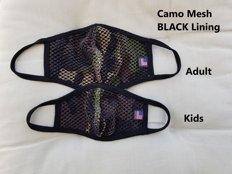May include: Two camo mesh face masks with black lining. The larger mask is labeled "Adult" and the smaller mask is labeled "Kids".
