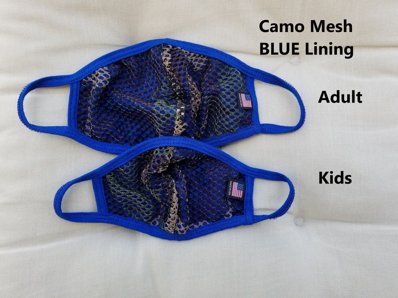 May include: Two face masks, one adult size and one kids size, made of camo mesh with blue lining. Both masks have a small American flag patch on the right side.