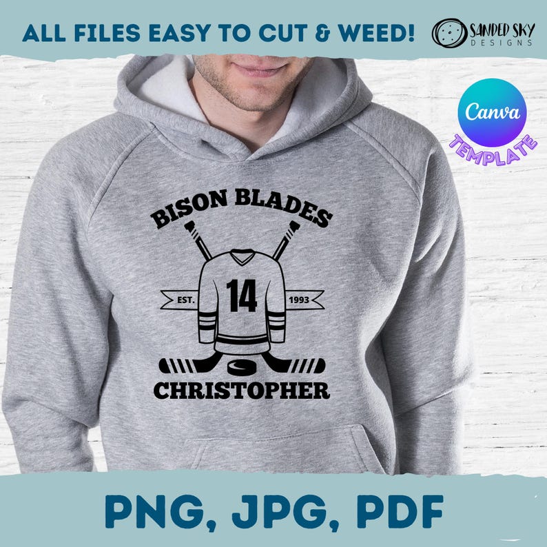 May include: A gray hoodie with a black graphic design of a hockey jersey with the number 14, two crossed hockey sticks, and the text "Bison Blades Est. 1993 Christopher".
