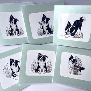 May include: A set of six square greeting cards with a light green border. Each card features a central white square containing a detailed illustration of a black and white Border Collie dog surrounded by colorful wildflowers and floral accents.
