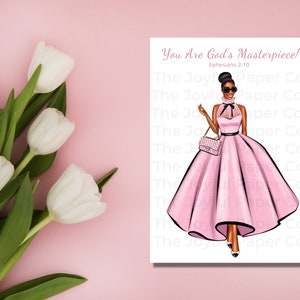 May include: A digital illustration of a Black woman wearing a pink dress and holding a purse. The text "You Are God's Masterpiece! Ephesians 2:10" is printed on the image.