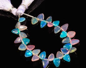 May include: A strand of iridescent opal beads in shades of blue, pink, and white. The beads are teardrop shaped and strung on a silver wire.