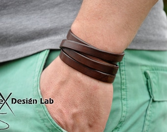 May include: A dark brown leather wrap bracelet consisting of multiple strands that circle the wrist. The logo for Alex Design Lab is visible in the bottom left corner, featuring a needle and thread graphic integrated with the brand name text.