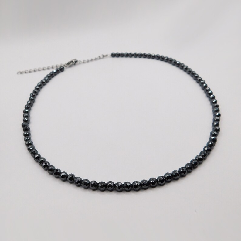 May include: A black hematite beaded necklace with a silver clasp.