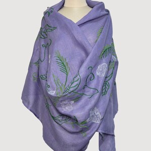Lavender linen head scarf features exquisite floral embroidery with a botanical motif of blooming flowers and winding leaves. The natural linen fabric of natural linen scarf