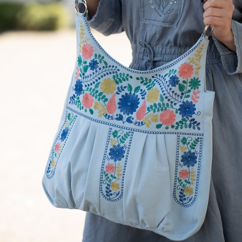 Embroidered hobo bag in blue with colorful floral embroidery. Oversize hippie shoulder bag is made of linen and cotton fabrics. Floral embroidery is of high quality, Blue linen bag you can wear as a shoulder bag