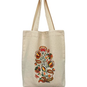 Beige canvas tote bag with folk floral embroidery.