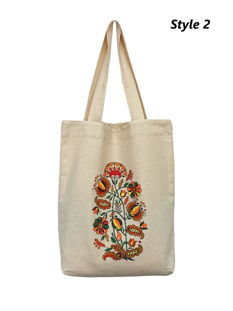 Beige canvas tote bag with folk floral embroidery.