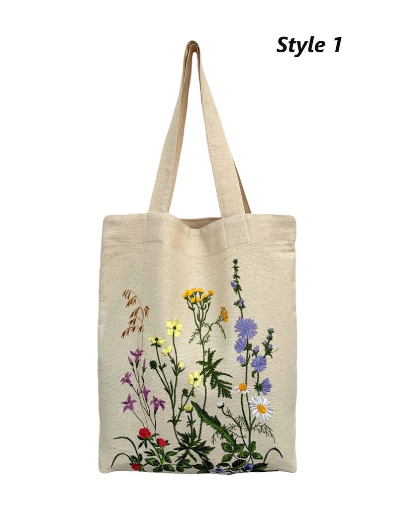 Beige canvas tote bag with botanical embroidery.
