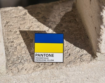 May include: A blue and yellow color swatch with the Pantone color names "Freedom Blue" and "Energizing Yellow" printed below.