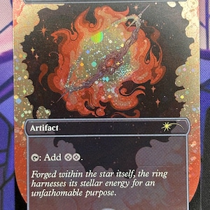 May include: A Sol Ring card with a fiery, celestial design. The card features the text "Sol Ring" at the top, with a central illustration of a ring within a swirling orange and red nebula. The card also includes the text "Artifact" and flavor text.
