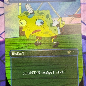 May include: A collectible card featuring SpongeBob SquarePants with the text "COUNTERSPELI" at the top. The card has a green and blue background with the text "iNsTanT" and "COUNTER tARgeT sPeLl." at the bottom. The card is a Wizards of the Coast product.