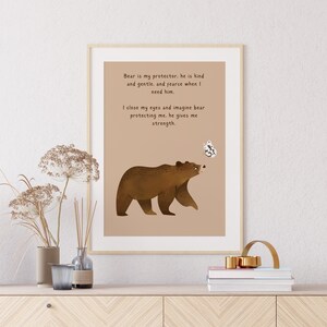 May include: A brown bear with a butterfly above its head is featured on a beige background with the text "Bear is my protector, he is kind and gentle, and fierce when I need him. I close my eyes and imagine bear protecting me, he gives me strength."