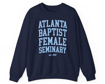 May include: A navy blue crewneck sweatshirt featuring light blue block lettering that reads ATLANTA BAPTIST FEMALE SEMINARY with the text est. 1881 in a smaller script font underneath. The garment has long sleeves and a ribbed collar and cuffs.