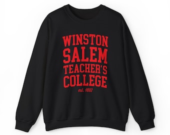 May include: Black crewneck sweatshirt with the words "WINSTON SALEM TEACHER'S COLLEGE" in red block letters. The text "est. 1892" is below the college name. The sweatshirt is a classic style.
