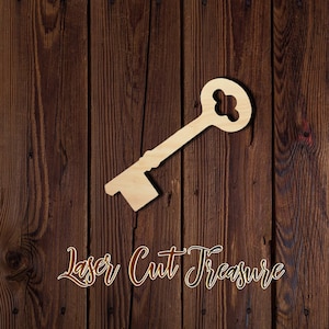 May include: A wooden key cutout with a decorative keyhole design. The key is on a brown wood background with the text "Laser Cut Treasure".