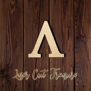 May include: A wooden cutout of the letter A, painted in a light wood color. The letter is set against a dark brown wood background. The text "Laser Cut Treasure" is written in cursive at the bottom of the image.