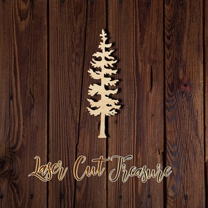 May include: A laser cut wooden pine tree silhouette on a brown wood background. The text "Laser Cut Treasure" is written below the tree.