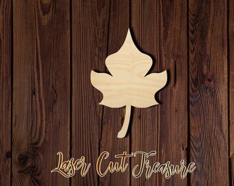 May include: A wooden cutout of a maple leaf, with a light brown color, against a dark brown wood background. The leaf is a simple shape with five points and a stem.