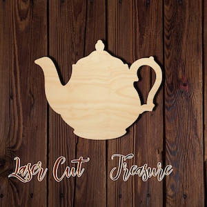 May include: A wooden cutout of a teapot, painted in a light brown color, against a dark brown wood background. The cutout is labeled "Laser Cut Treasure".