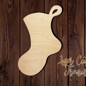 May include: A plain wooden Christmas stocking cutout, ready to be painted or decorated. The stocking is made of unfinished wood and has a simple, classic shape.