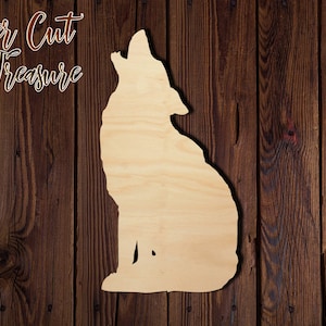 May include: A laser cut wooden cutout of a wolf howling at the moon. The cutout is unpainted and has a natural wood finish.
