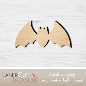 May include: A wooden bat cutout with outstretched wings. The bat is made of light-colored wood and has a simple, stylized design. The bat is a Halloween or fall-themed craft supply.