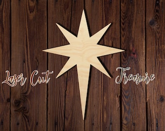 May include: Laser cut wooden star with a pointed tip and eight points. The star is light brown and is set against a dark brown wood background. The text "Laser Cut Treasure" is written in white on the background.